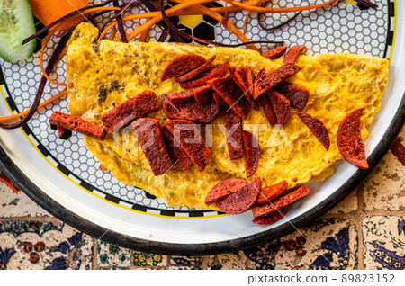 Omelet with sausage and vegetables in white plate Omelet with sausage and vegetables in white plate 89823152