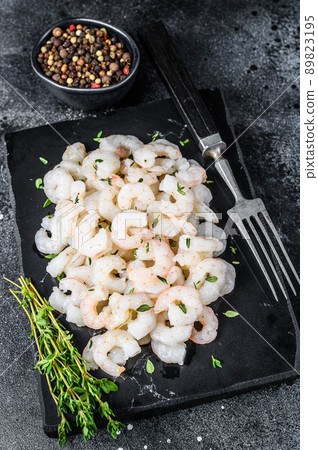 Peeled Shrimps, Prawns on a marble board. Black background. top view 89823195