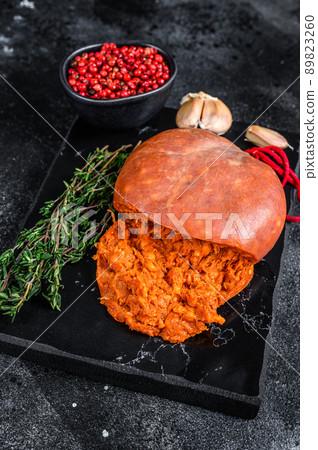 Balearic Sobrassada cured meat sausage from ground pork, paprika and spices. Black background. Top view Balearic Sobrassada cured meat sausage from ground pork, paprika and spices. Black background. Top view 89823260
