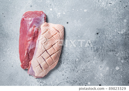 Duck breast fillet on butcher table, raw poultry meat. Gray background. Top view. Copy space Duck breast fillet on butcher table, raw poultry meat. Gray background. Top view. Copy space 89823329