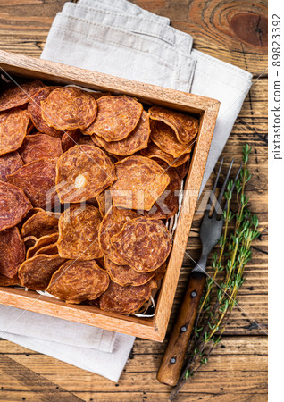 Meat Jerky from beef and pork meat. wooden background. Top view Meat Jerky from beef and pork meat. wooden background. Top view 89823392