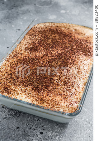 Tiramisu Italian dessert topped with cocoa. Gray background. Top view 89823400