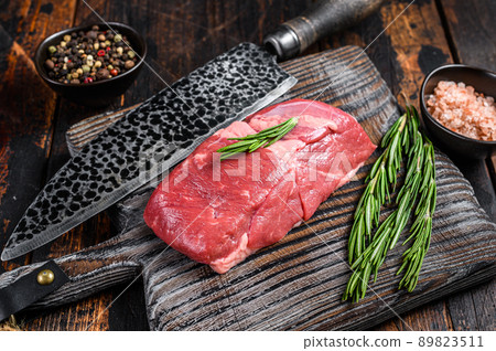 Raw veal sirloin meat steak on a wooden board. wooden background. Top view Raw veal sirloin meat steak on a wooden board. wooden background. Top view 89823511