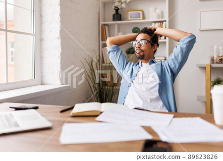 Pensive black businessman looking out of window in office 89823826