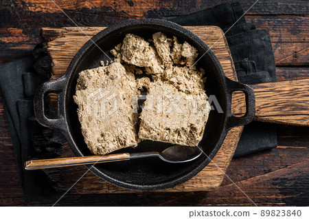 Halva with sunflower seeds and honey in pan. Wooden background. Top view Halva with sunflower seeds and honey in pan. Wooden background. Top view 89823840