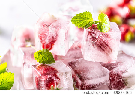 Strawberries frozen in ice cubes with mellisa leaves Strawberries frozen in ice cubes with mellisa leaves 89824166
