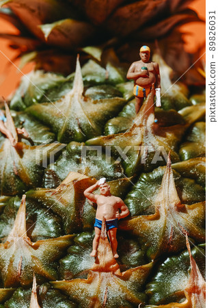 miniature man in swimsuit wiping his sweat 89826031