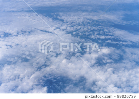 View of the sky from the window of an airplane Blue sky and flowing white clouds View of the sky from the window of an airplane Blue sky and flowing white clouds 89826759