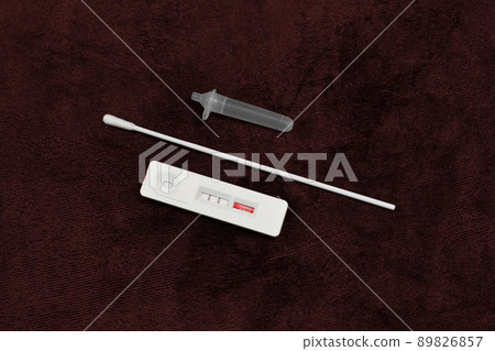 Antigen test kit (ATK) Covid-19 positive test result on dark red color background 89826857