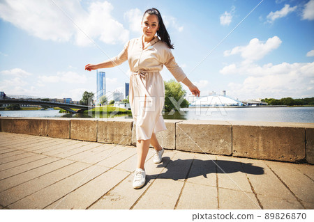 girl walking on a sunny day in the city girl walking on a sunny day in the city 89826870