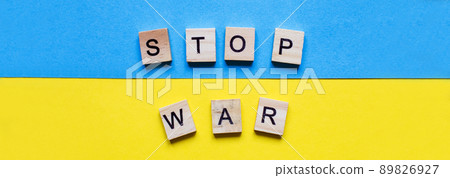 the inscription stop war made by wooden cubes on the ukrainian flag background 89826927