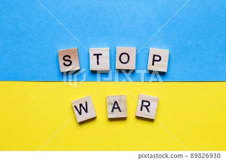 the inscription stop war made by wooden cubes on the ukrainian flag background 89826930