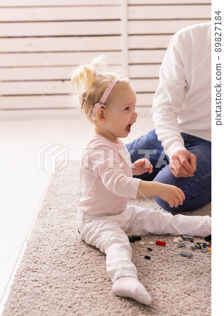 Happy child girl with cochlear implant having fun with her father - hearing aid for deaf and innovative health technology and diversity concept Happy child girl with cochlear implant having fun with her father - hearing aid for deaf and innovative health technology and diversity concept 89827184