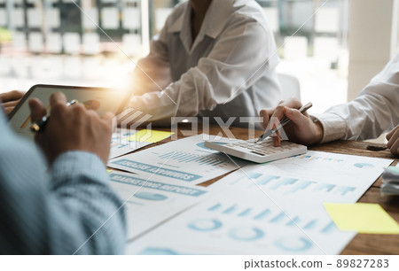 Business people analyzing investment graph meeting brainstorming and discussing plan in meeting room, investment concept Business people analyzing investment graph meeting brainstorming and discussing plan in meeting room, investment concept 89827283