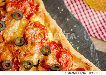 Homemade pizza on a wooden background 89828130
