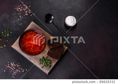 Traditional Ukrainian borsch. Bowl of red beet root soup borsch with green onion Traditional Ukrainian borsch. Bowl of red beet root soup borsch with green onion 89828332
