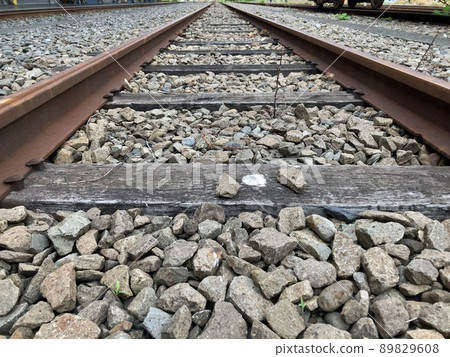 Old railroad tracks and freight trains 89829608