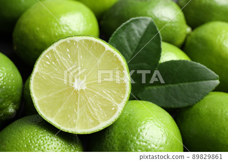 Fresh ripe juicy limes as background, closeup 89829861