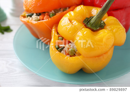 Tasty stuffed bell peppers on white wooden table, closeup 89829897