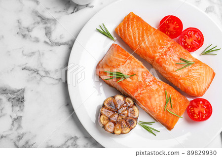 Delicious roasted fish served on white marble table, flat lay 89829930