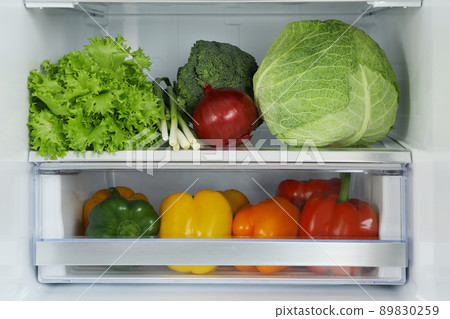 Open refrigerator full of fresh vegetables, closeup Open refrigerator full of fresh vegetables, closeup 89830259