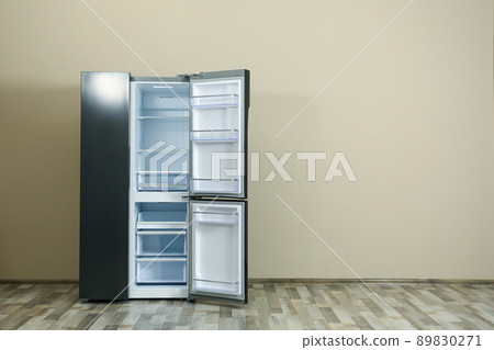 Modern refrigerator near beige wall, space for text 89830271