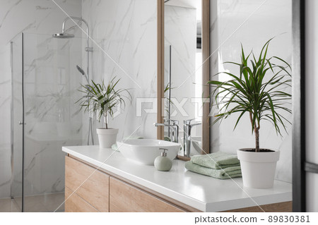 Large mirror and vessel sink in bathroom 89830381