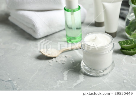 Different cosmetic products and aloe on grey marble table 89830449