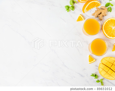 Mango orange juice smoothie grey concrete table. Fresh healthy drink. Mango orange juice smoothie grey concrete table. Fresh healthy drink. 89831012