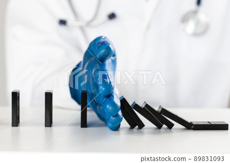 close up. virologist using dominoes to show a safe distance . 89831093