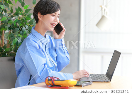 Engineer woman talking on the phone while looking at the PC 1 89831241