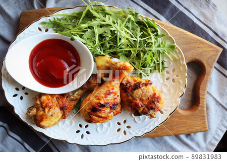 Dinner background. Grilled chicken legs with tomato sauce 89831983