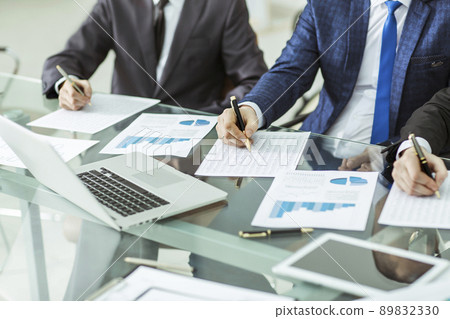 business team conducting analysis of marketing reports at the workplace business team conducting analysis of marketing reports at the workplace 89832330
