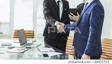 handshake Manager and customer in a modern office. handshake Manager and customer in a modern office. 89832331
