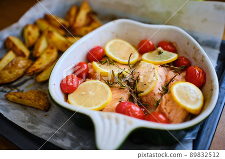 Salmon fish portions with cherry tomatoes and lemon 89832512
