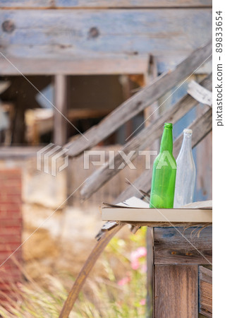 Two bottles in the yard of an  abandoned building in the Ghost Resort City of Varosha Famagusta, Cyprus 89833654