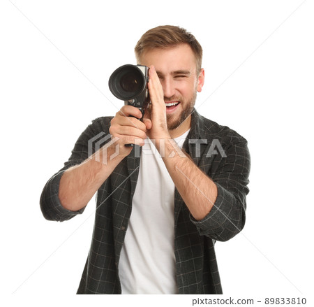 Young man using vintage video camera on white background Young man using vintage video camera on white background 89833810