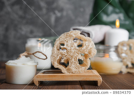 Natural soap, loofah scrubber on podium in bathroom. Zero waste in life. Relaxation spa concept, candles, beauty... Natural soap, loofah scrubber on podium in bathroom. Zero waste in life. Relaxation spa concept, candles, beauty... 89834370