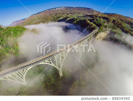 Montenegro. Dzhurdzhevich Bridge Over The River Tara foggy morning in Summer 89834593