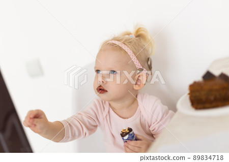 Cochlear implant for baby. Deaf child with hearing aid. Health care and medicine technology and innovations and diversity Cochlear implant for baby. Deaf child with hearing aid. Health care and medicine technology and innovations and diversity 89834718