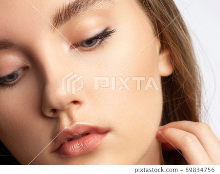 Glamour portrait of beautiful woman model with fresh daily makeup and romantic wavy hairstyle. Fashion shiny highlighter on skin, sexy gloss lips make-up and dark eyebrows Glamour portrait of beautiful woman model with fresh daily makeup and romantic wavy hairstyle. Fashion shiny highlighter on skin, sexy gloss lips make-up and dark eyebrows 89834756