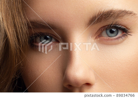 Macro shot of woman's beautiful eye with extremely long eyelashes. Sexy view, sensual look. Female eye with long eyelashes 89834766