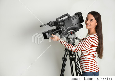 Operator with professional video camera on white background 89835154