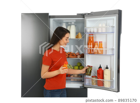 Young woman choosing products from refrigerator on white background Young woman choosing products from refrigerator on white background 89835170