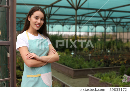 Female business owner in greenhouse. Space for text 89835172