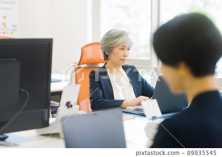 Senior business woman working at the office Senior business woman working at the office 89835545
