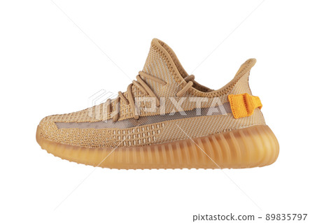 Beige rag sneaker on a white background. Beige rag sneaker on a white background. 89835797