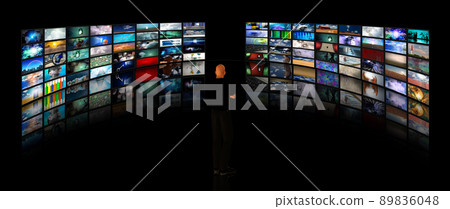 Man viewing video displays Man viewing video displays 89836048