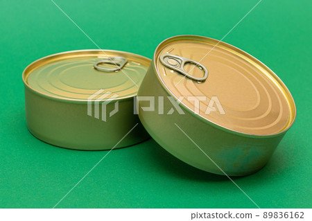 Unopened Tin Cans with Blank Edges on Green Background 89836162