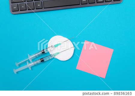 Vaccination or Revaccination Concept - Two Medical Syringe on Blue Table 89836163